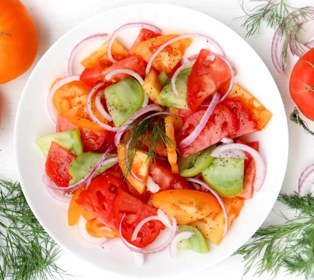 tomato-salad-on-a-white-plate-with-dill-on-the-side