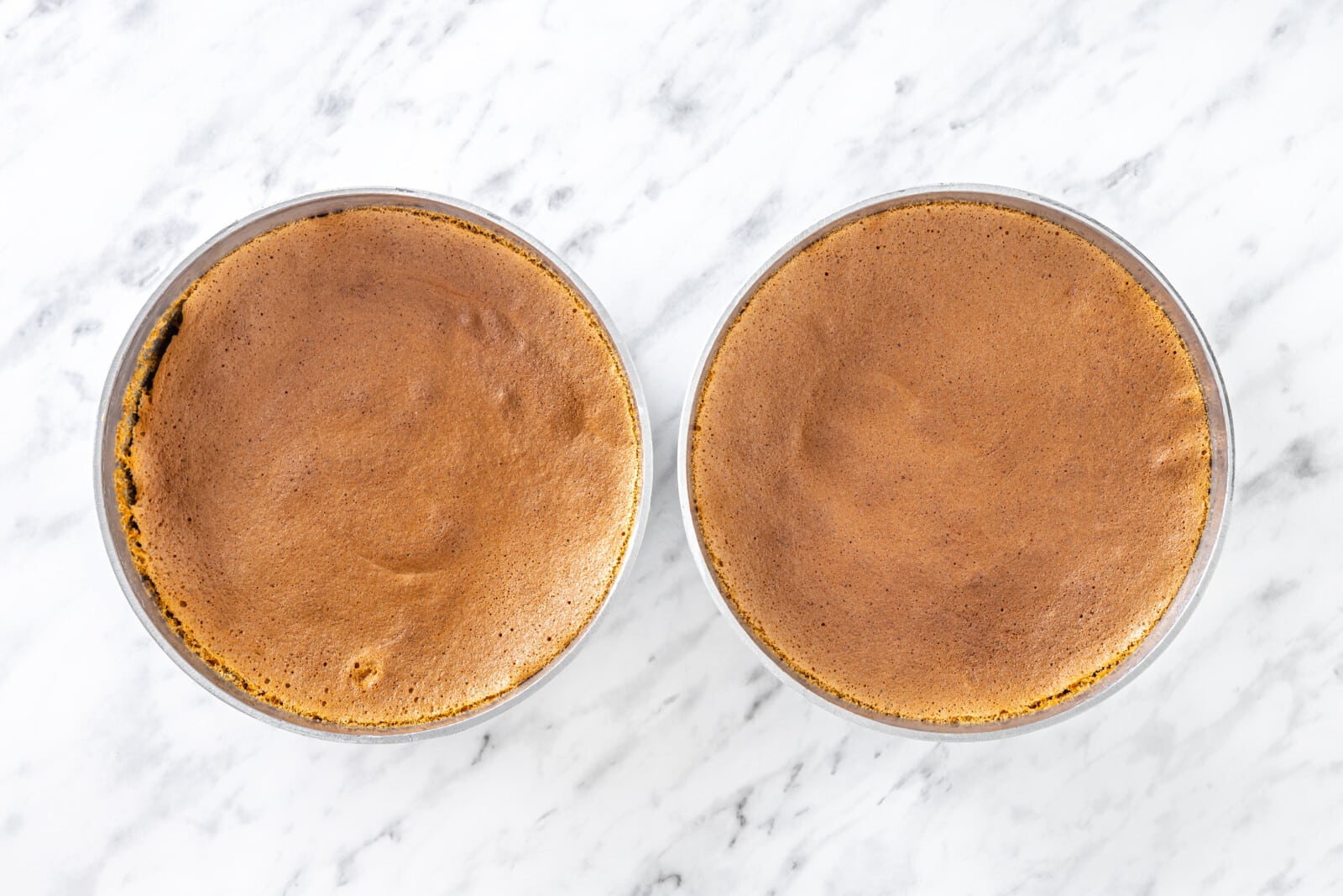 Baked cake layers in springform pans.