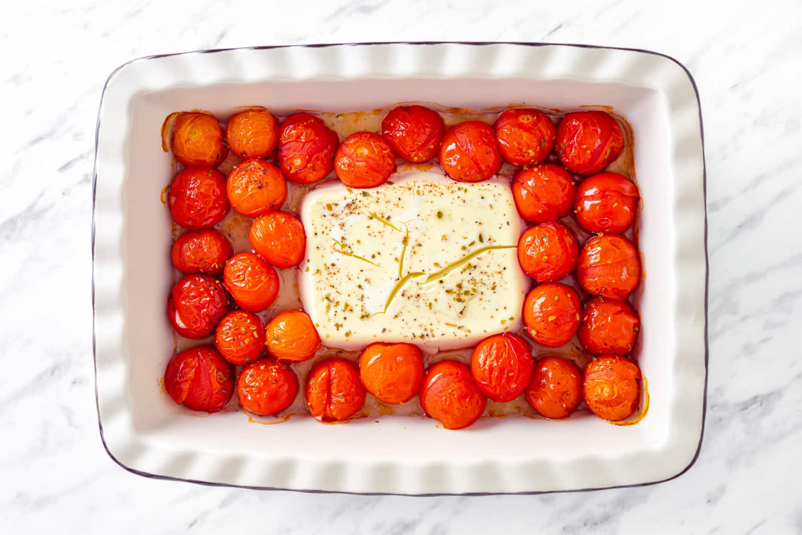 the baked feta and cherry tomatoes in a baking dish