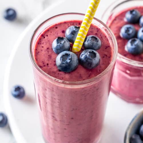 close up blueberry smoothie with fresh blueberries.