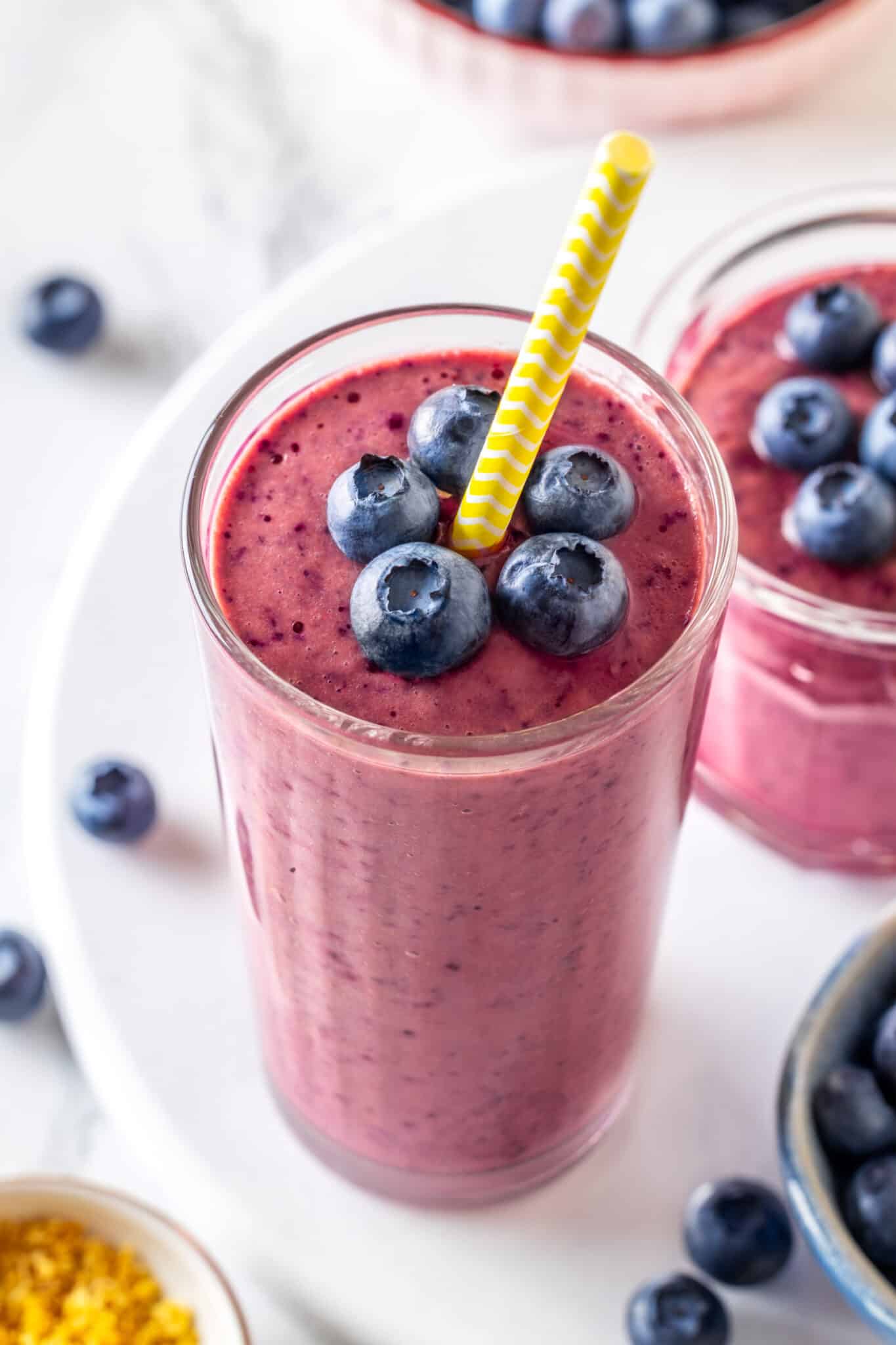 close up blueberry smoothie with fresh blueberries.