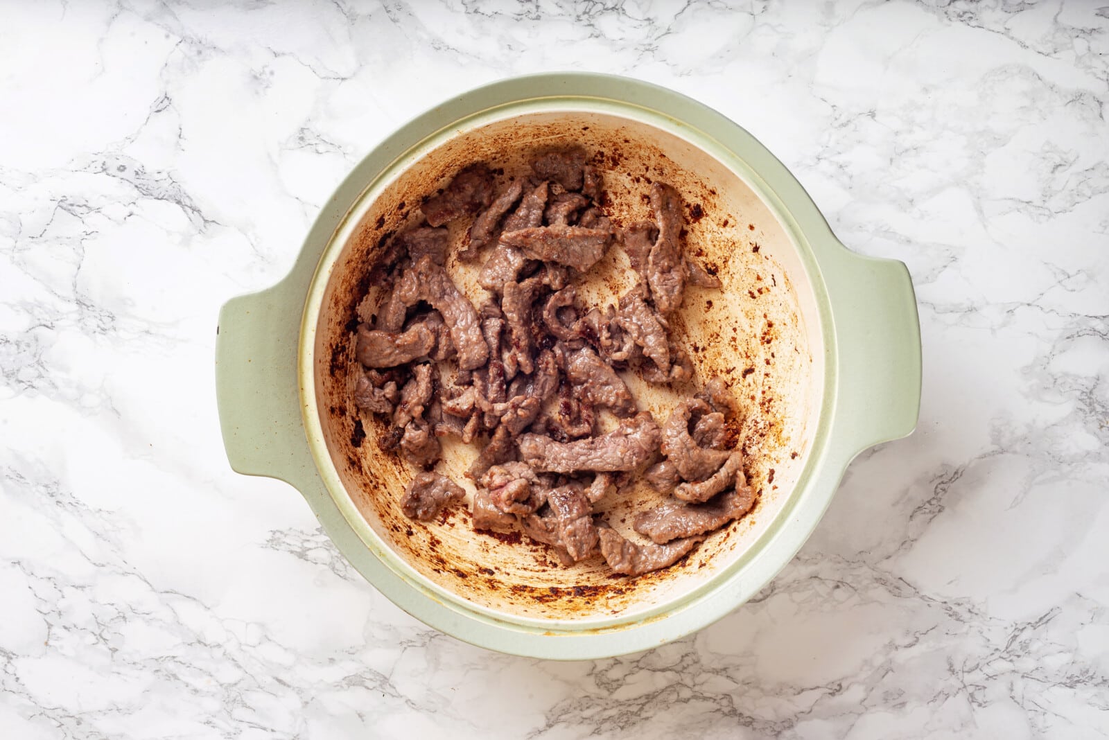 beef slices sauteed in a sauce pan