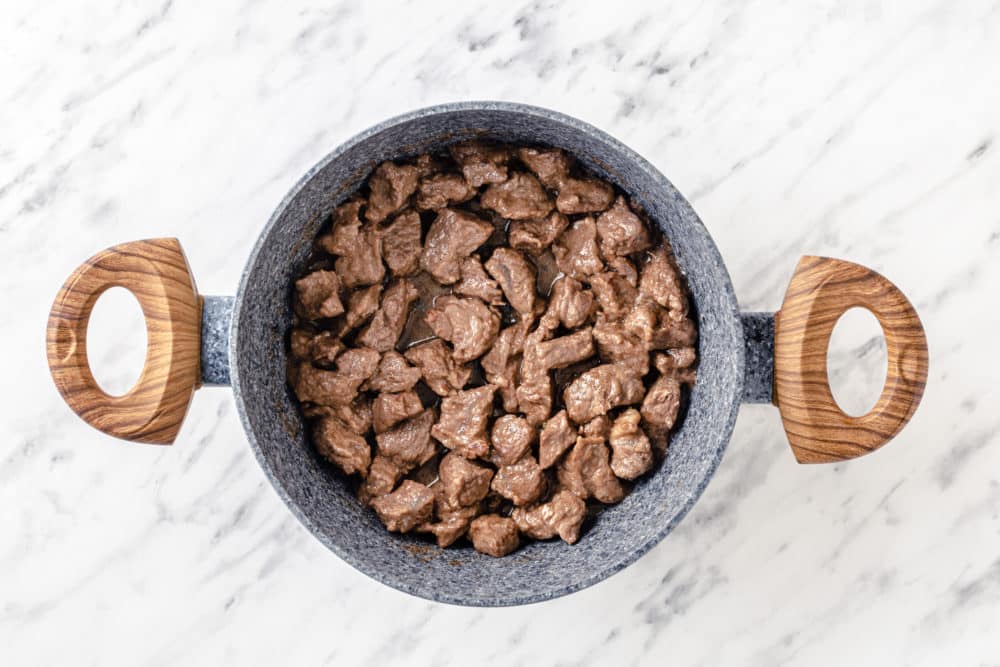 a grey pot with cooked beef.