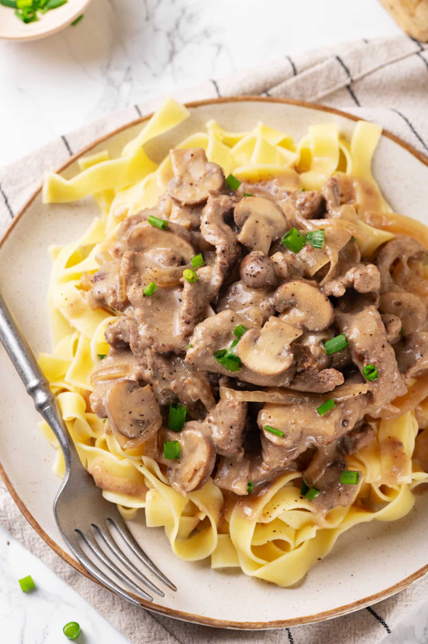 beef stroganoff with creamy sauce over egg noodles