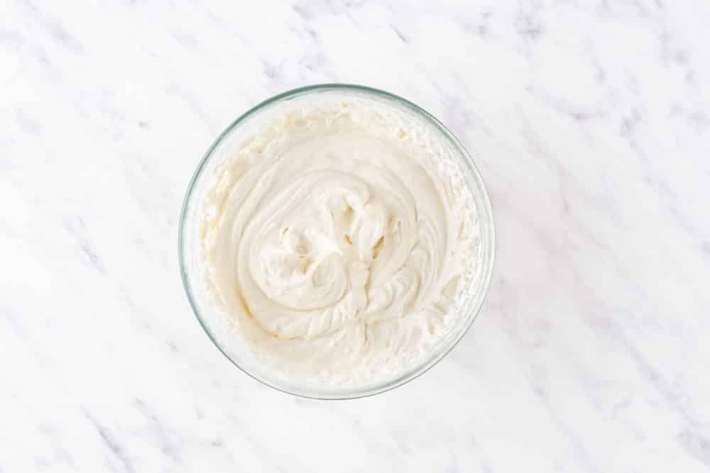 a glass bowl with cheesecake filling.