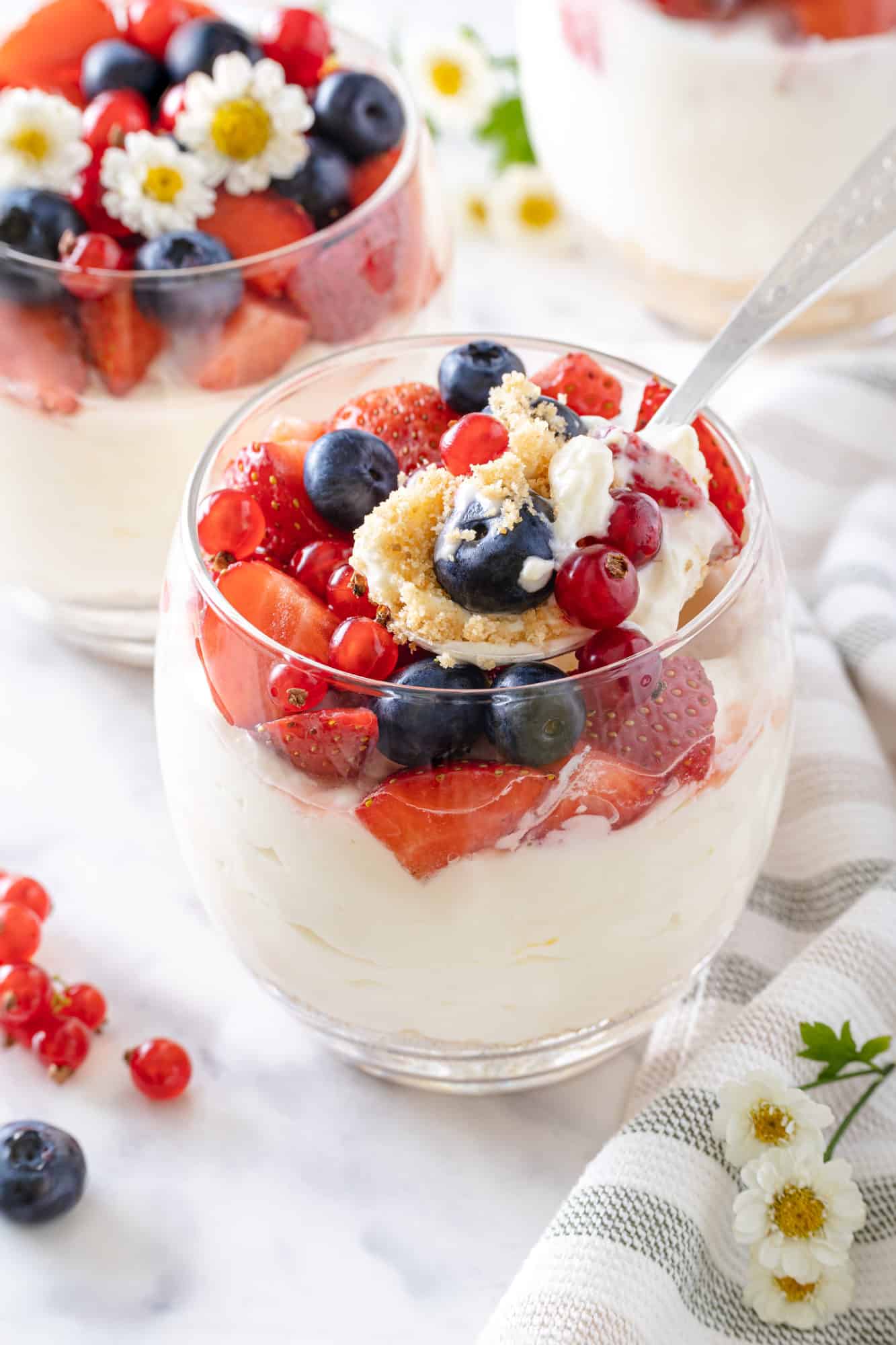 cheesecake in a glass cup with a spoon.