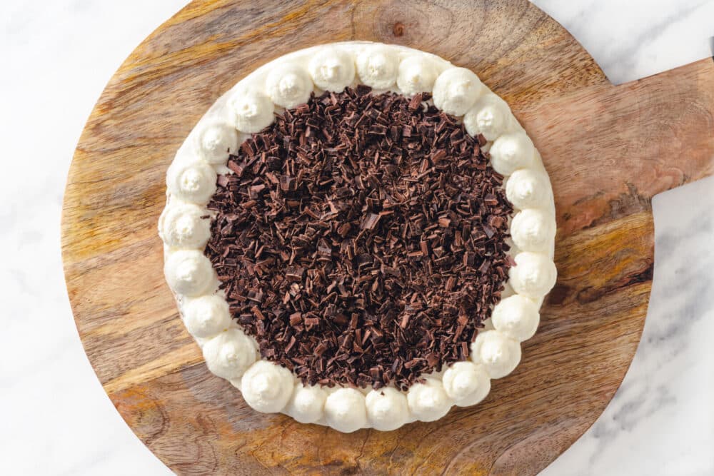 Cake decorated with frosting and chocolate shavings.