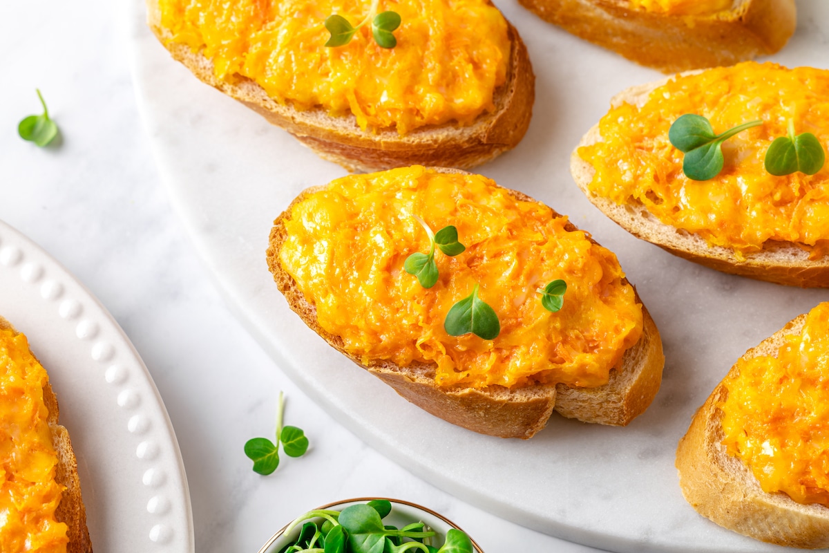 baked carrot melt appetizer with microgreens sprinkled on top each appetizer.