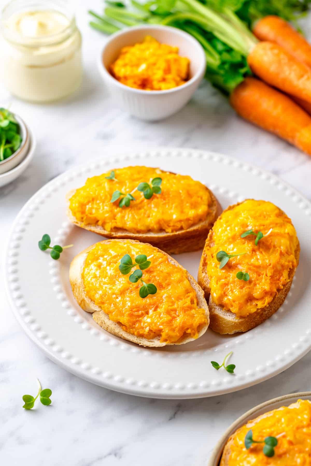 baked carrot melt appetizer on a white plate.