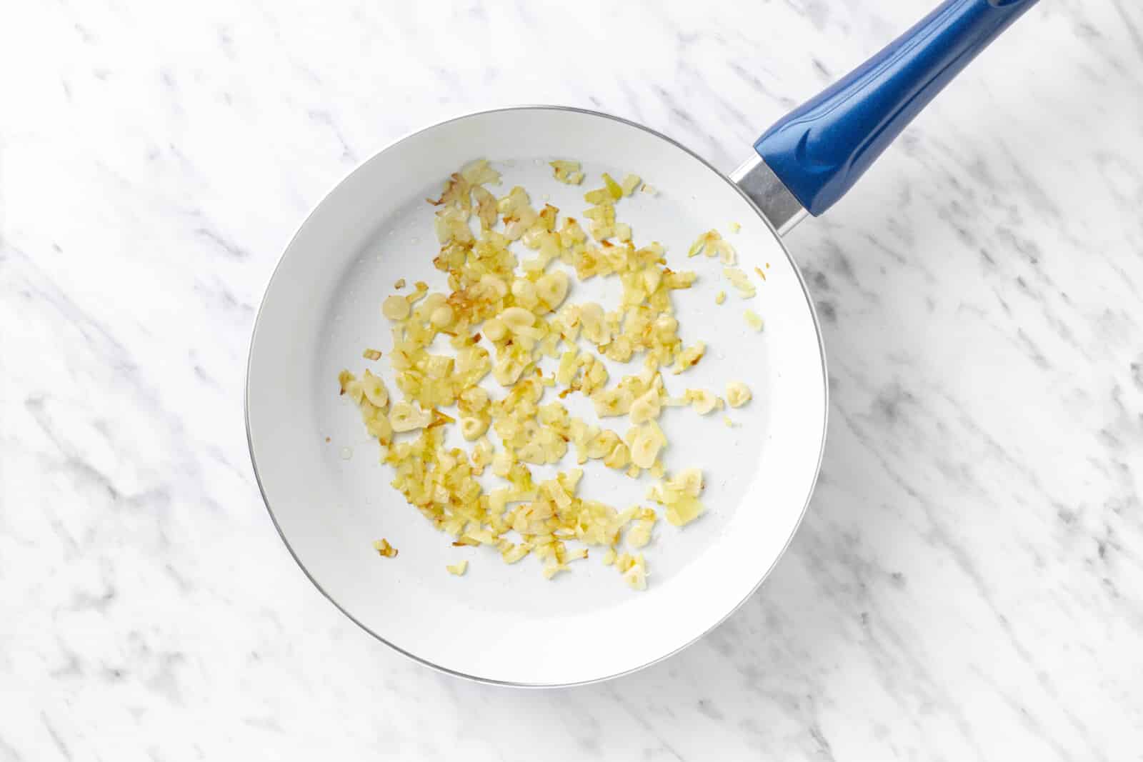 cook the onion and garlic in a pan.