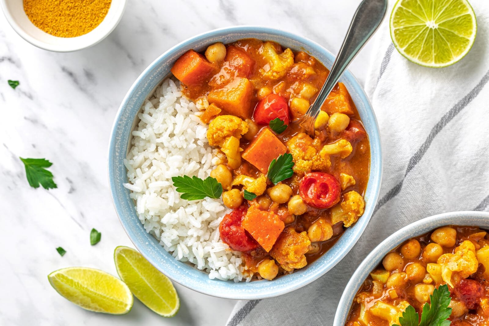 cauliflower and chickpea curry in a bowl with rice.