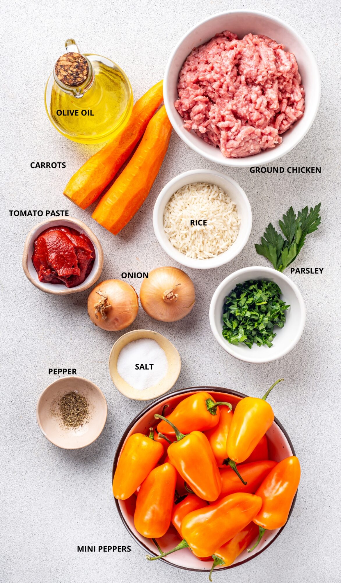 Chicken stuffed peppers ingredients- mini peppers, ground chicken, parsley, pepper, salt, onion, rice, olive oil, carrots, and tomato paste.