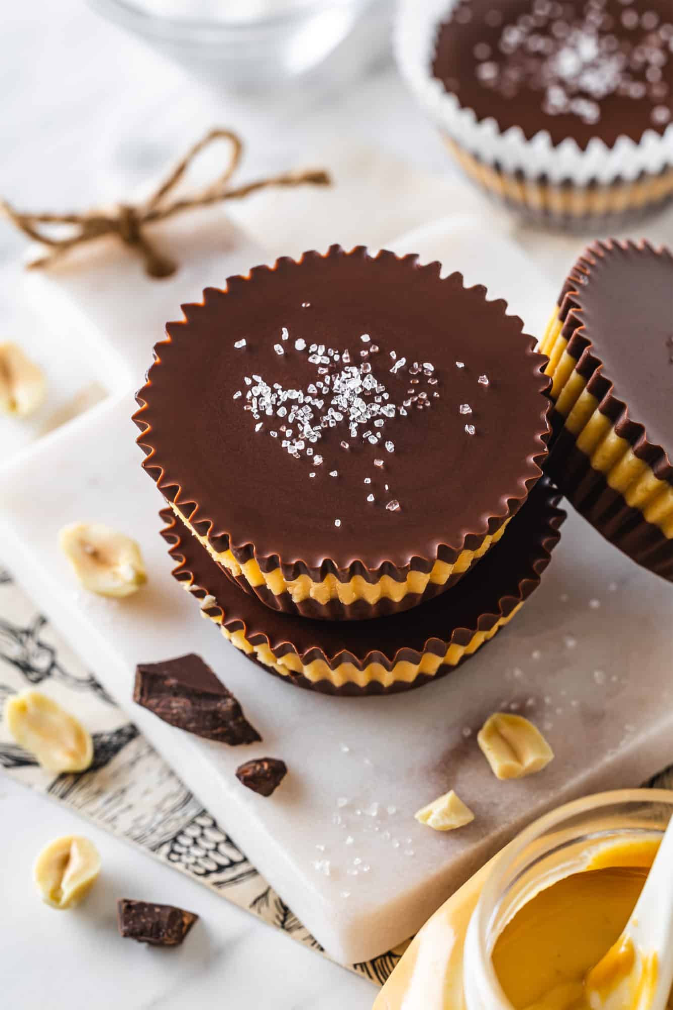 Peanut butter cups stacked with salt on top.