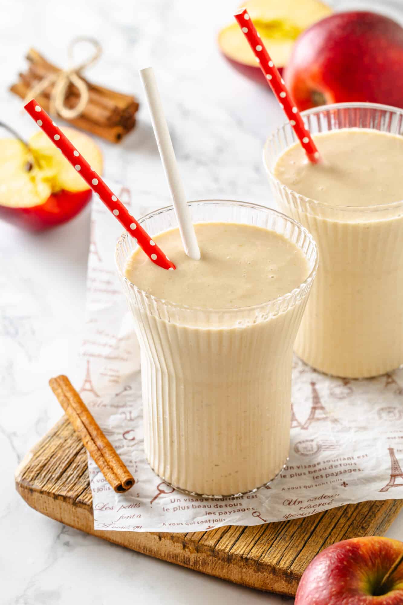 Cinnamon and apple pie smoothie with straws.