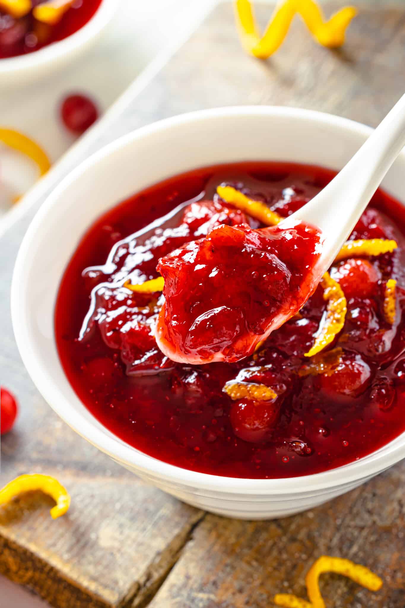 a white bowl with cranberry sauce in it.