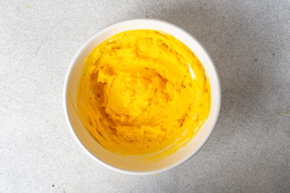 Egg yolk mixture in a white bowl.