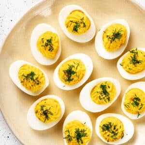 Deviled eggs on a decorative plate.