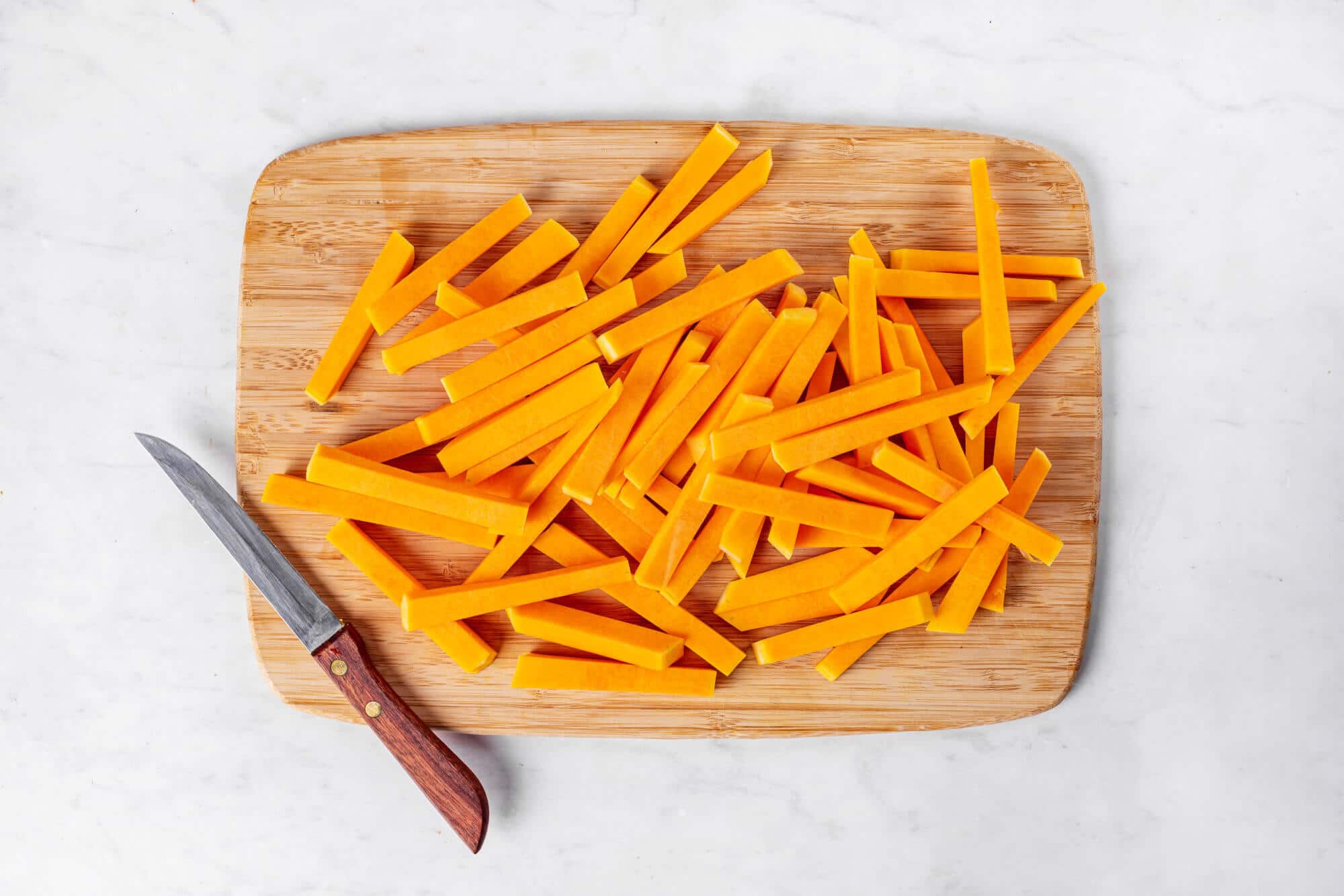 chopped-butternut-squash-on-a-wooden-board-with-a-knife