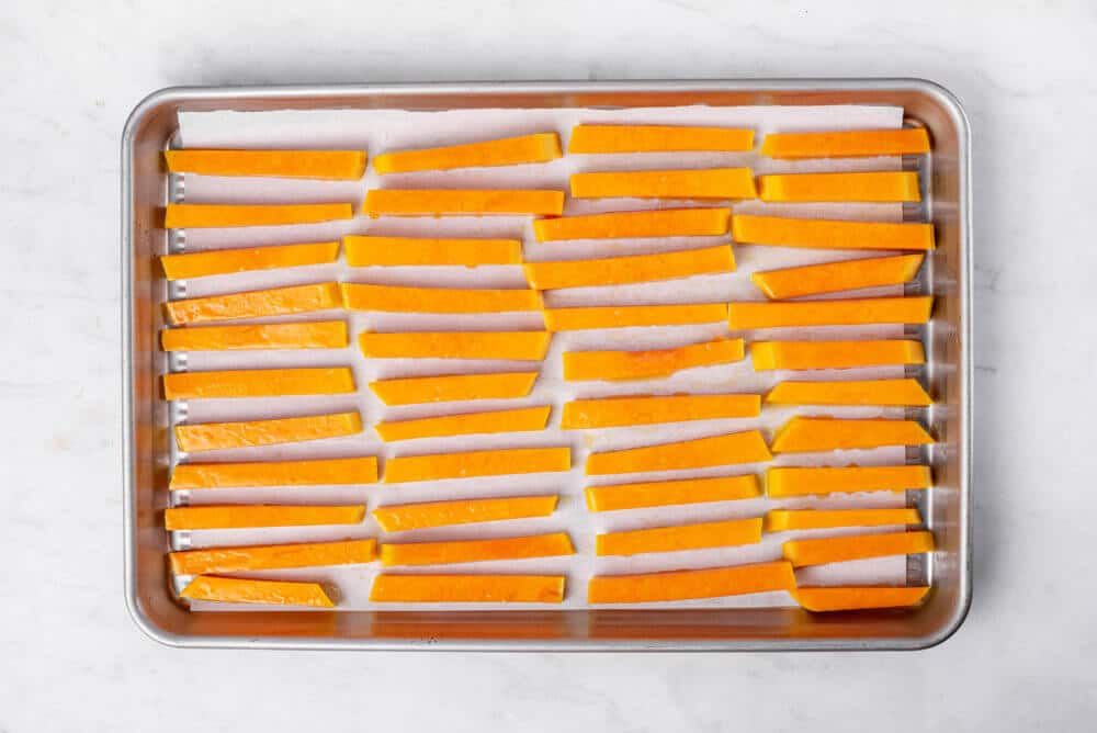 squash-fries-on-a-baking-tray-with-parchment-paper