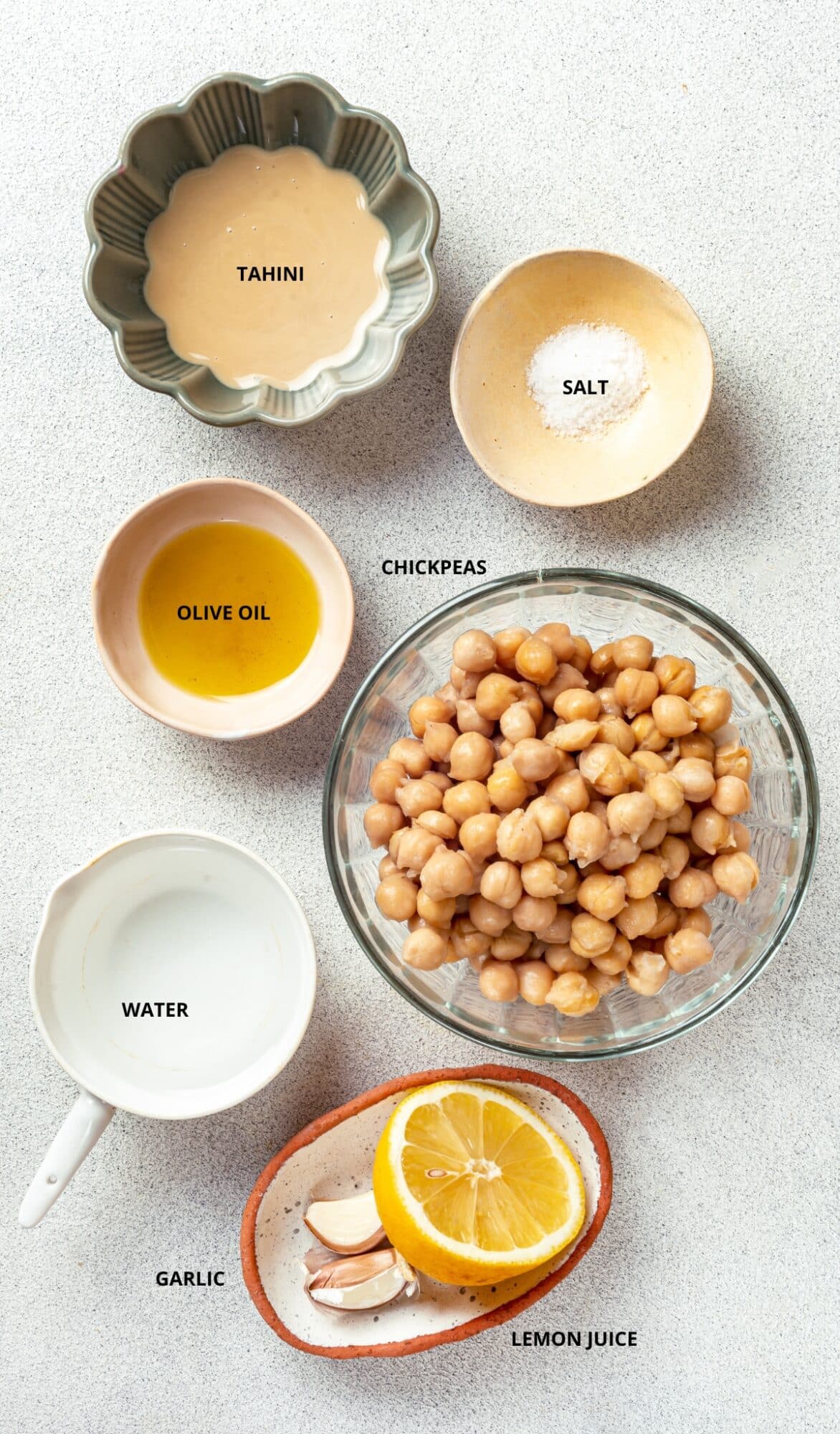 Hummus ingredients- tahini, salt, chickpeas, water, lemon, olive oil, and garlic.