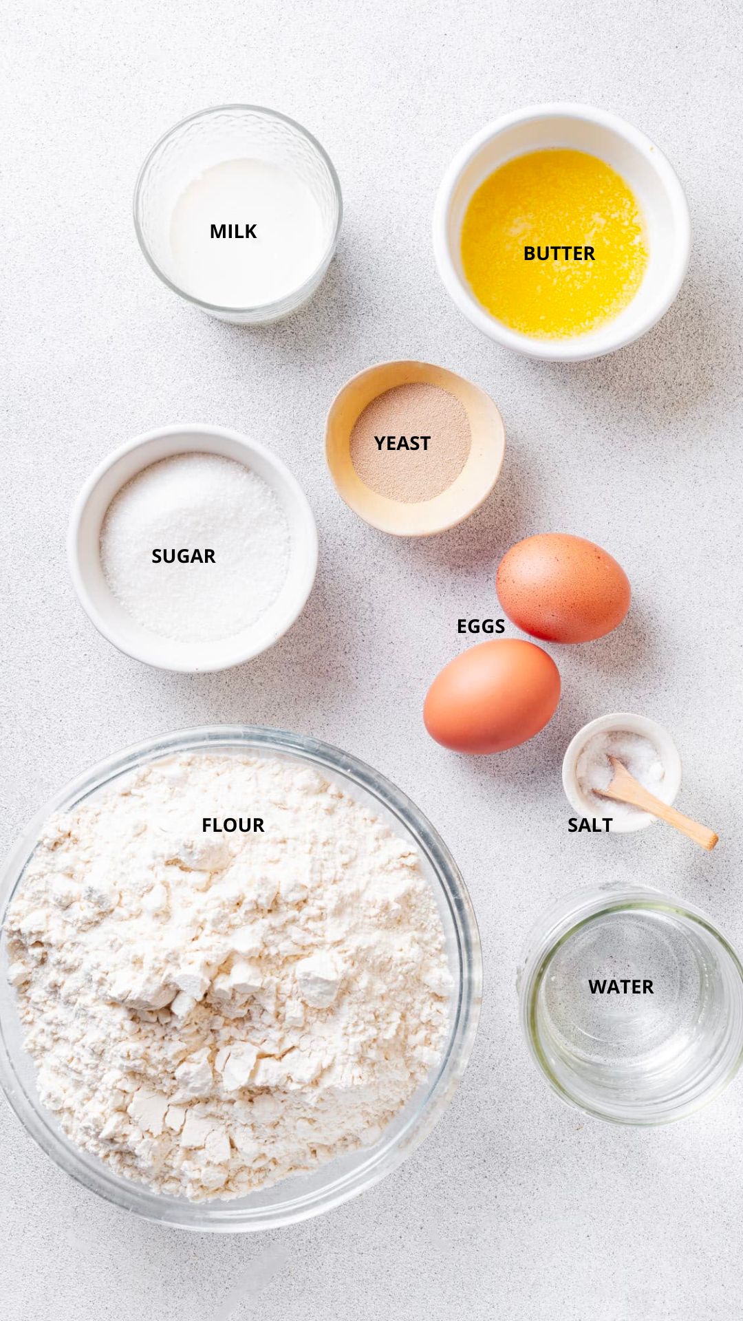 dinner rolls ingredients- butter, milk, yeast, eggs, sugar, flour, salt, and water.