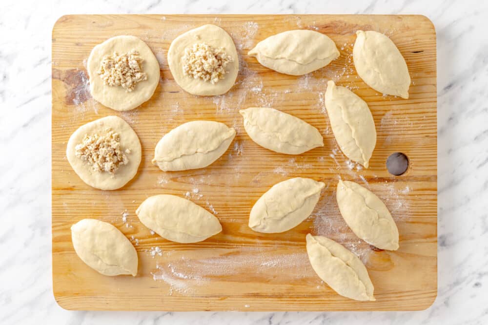 Filling dough with meat filling for piroshki.