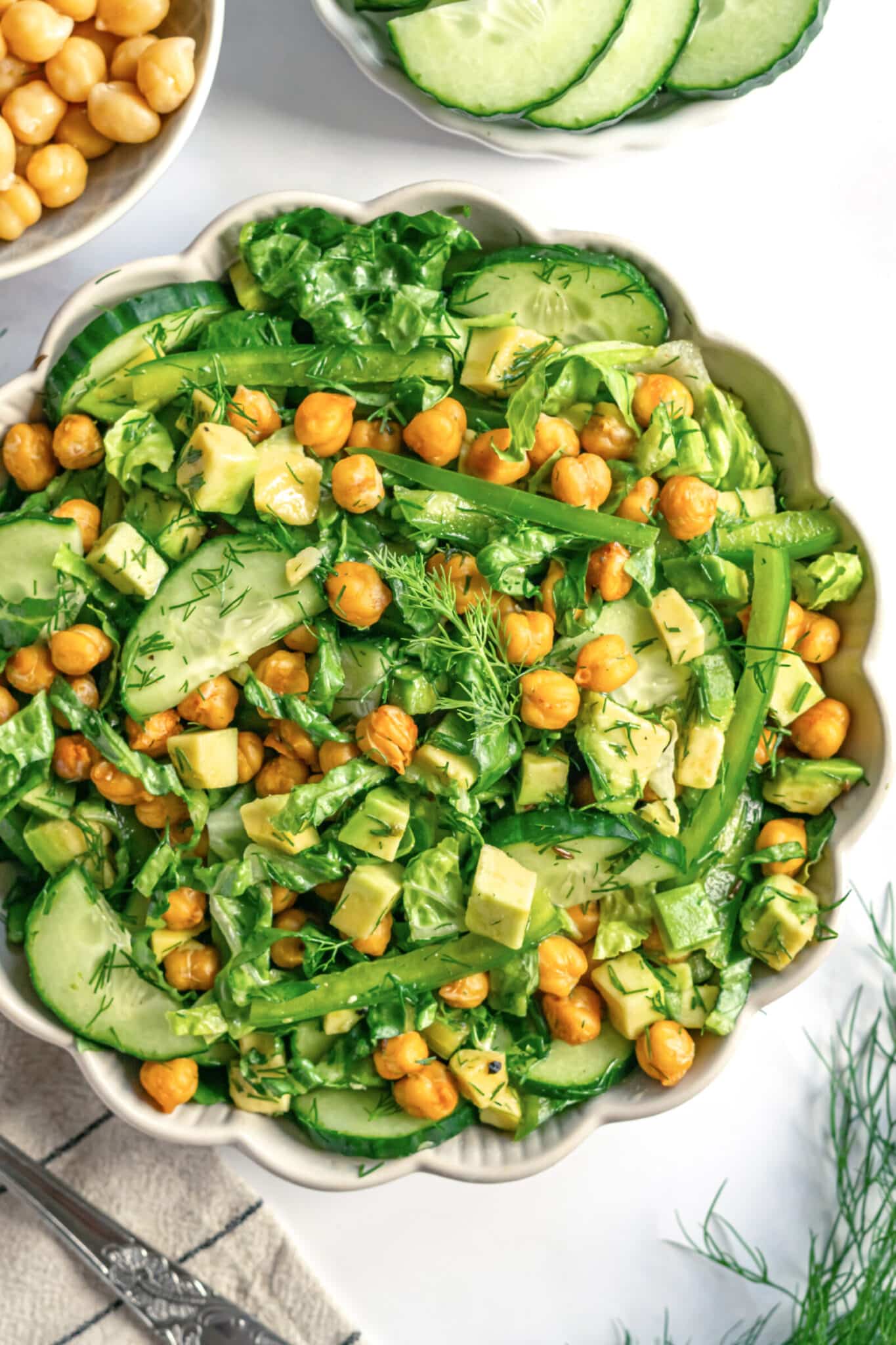 roasted chickpeas mixed with green vegetables in a bowl and olive oil.