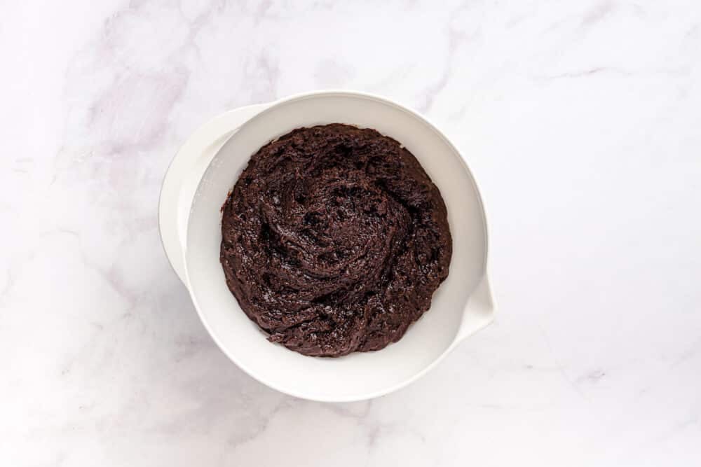 gluten free chocolate muffin batter in a white bowl.