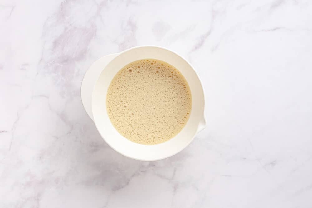 batter for gluten free chocolate muffins in a white bowl.