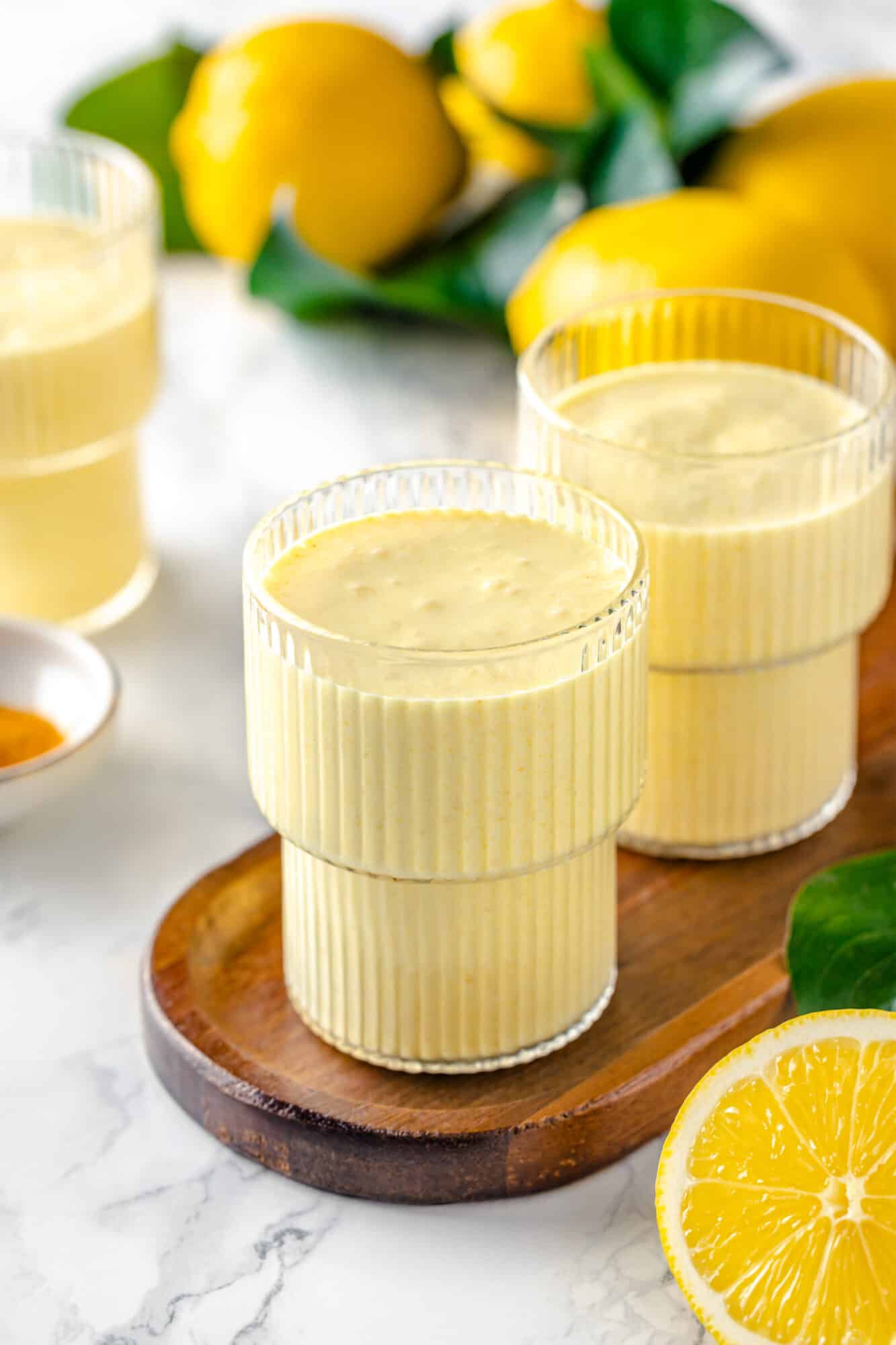 three cups of smooth blended lemon smoothie.