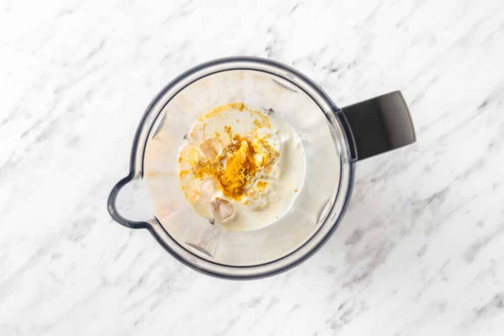 ingredients in a blender for lemon turmeric smoothie before blending.