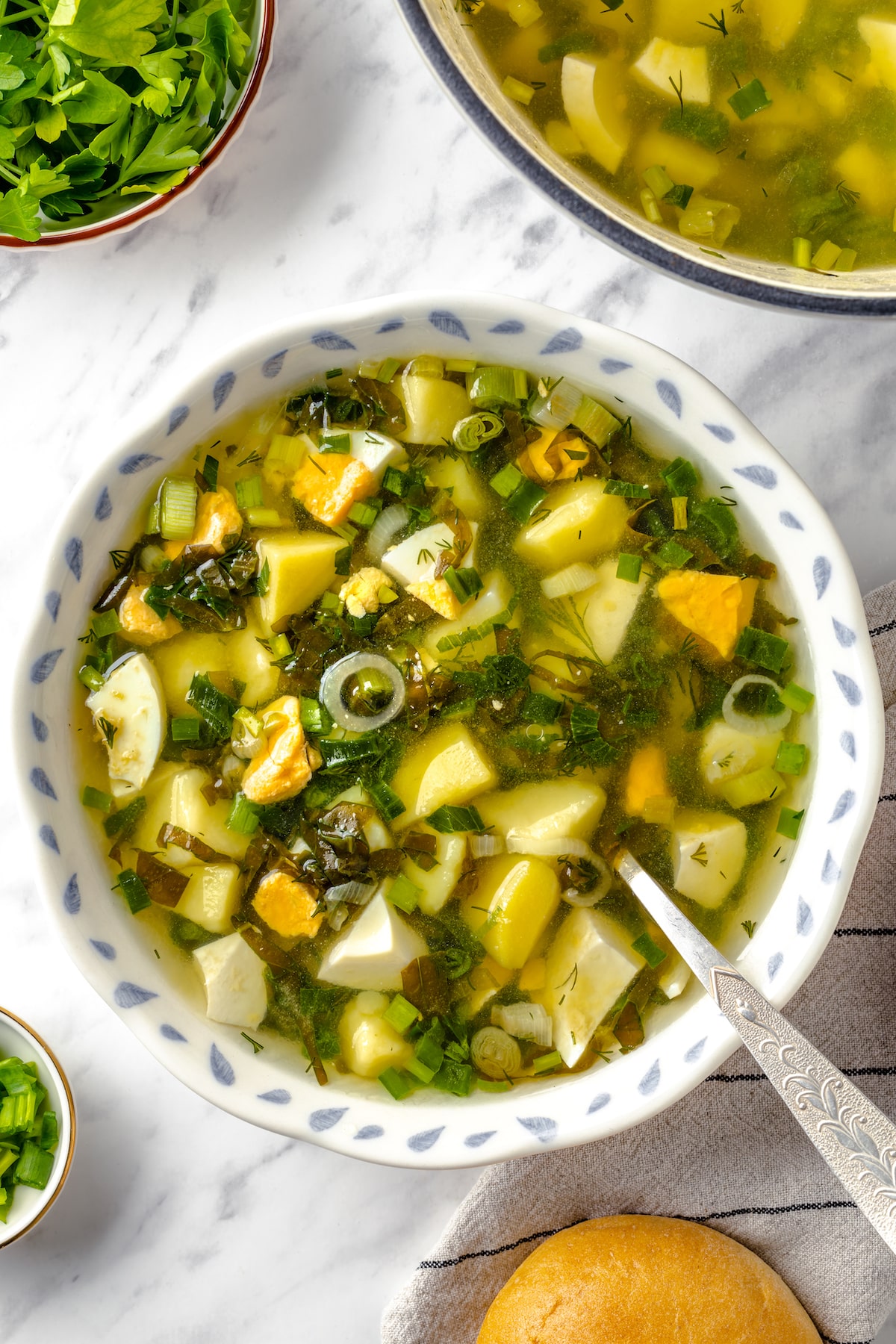 Green Sorrel Soup in a bowl with spoon