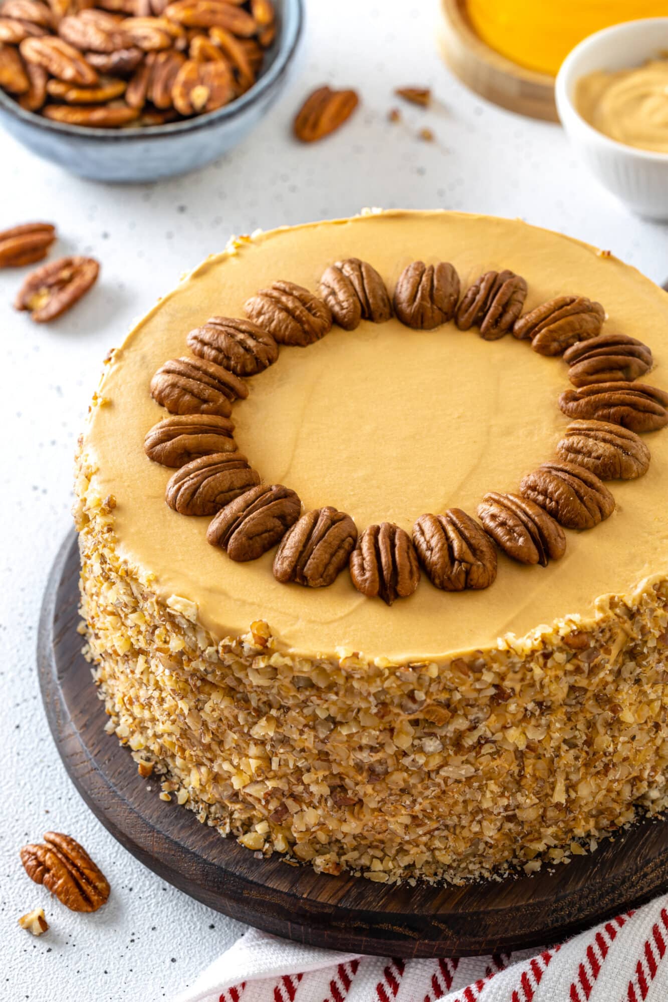 Honey pecan cake on a dark plate.