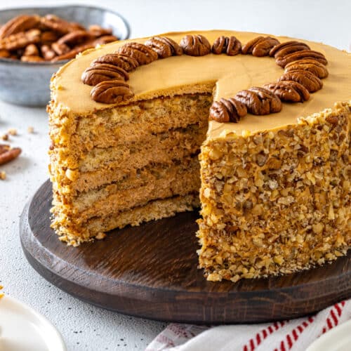 Honey pecan cake serving on a wooden board.