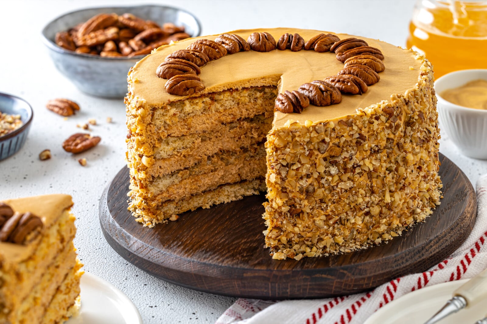 Honey pecan cake serving on a wooden board.