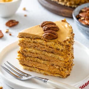 Honey pecan cake slice on a white plate ready to eat.