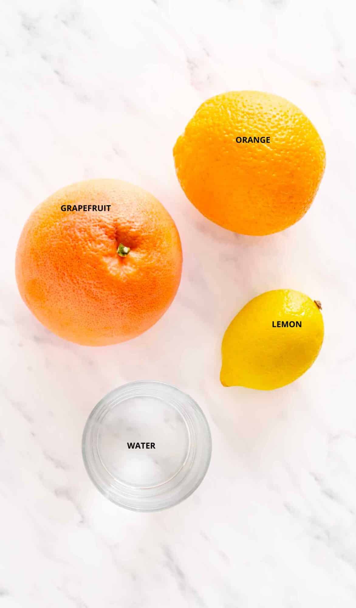 3 ingredient energy fruit smoothie ingredients with labels orange grapefruit lemon and water.