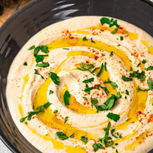 Hummus in a bowl with olive oil on top.