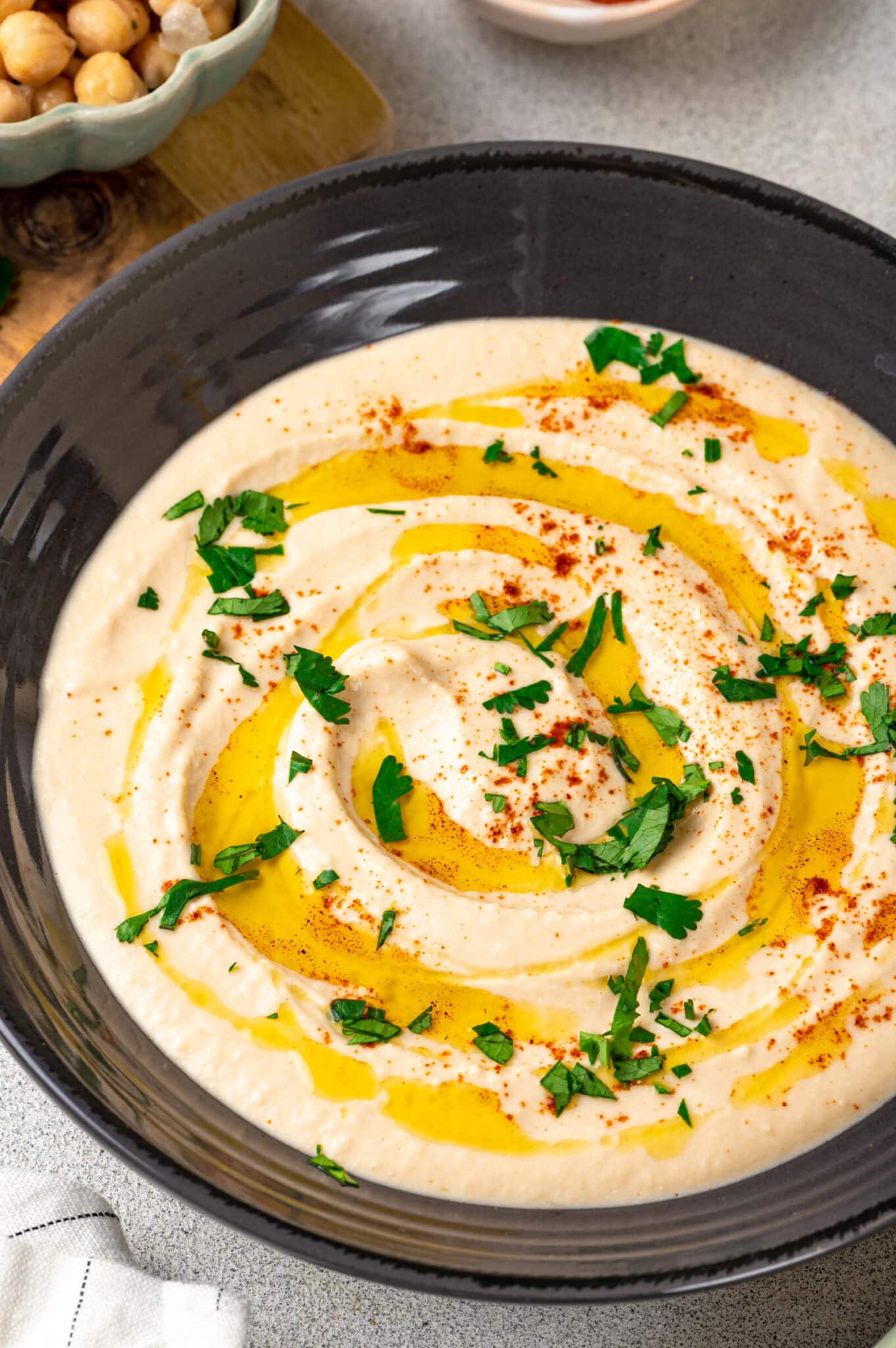 Hummus in a bowl with olive oil on top.