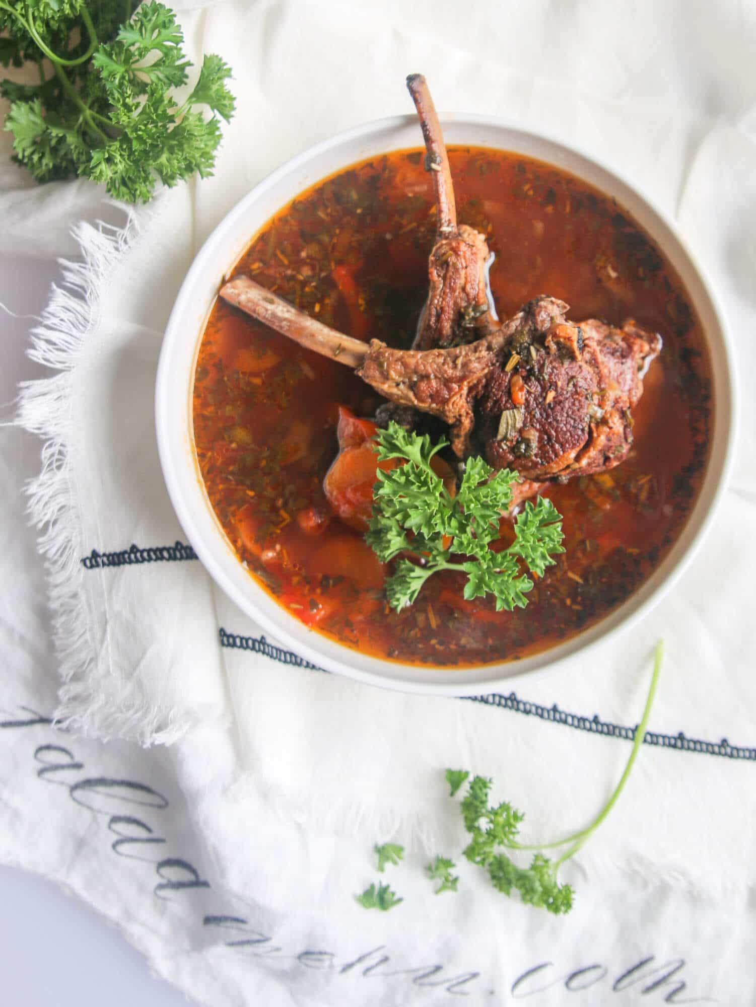 lamb-soup-in-a-white-bowl-on-a-white-towel