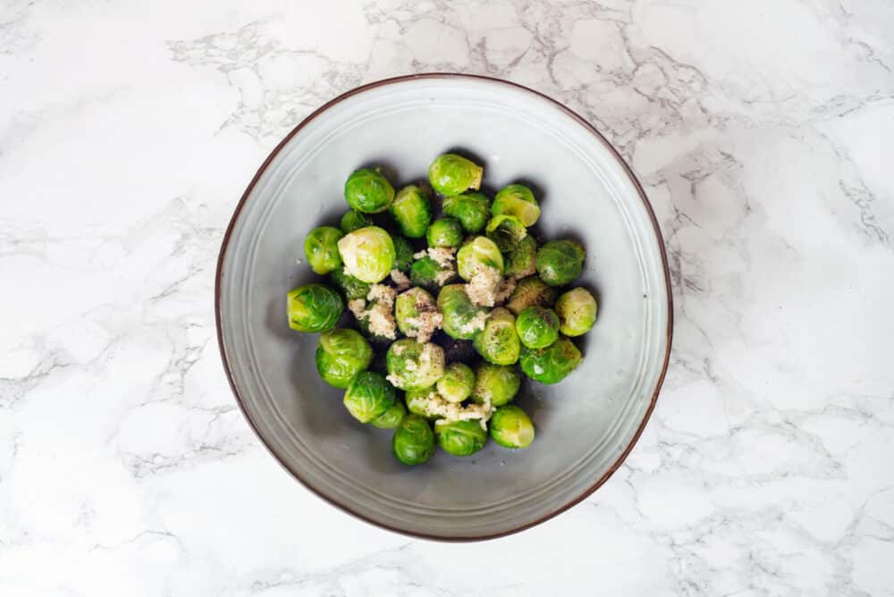 Brussels sprouts with spices and garlic in a bowl.