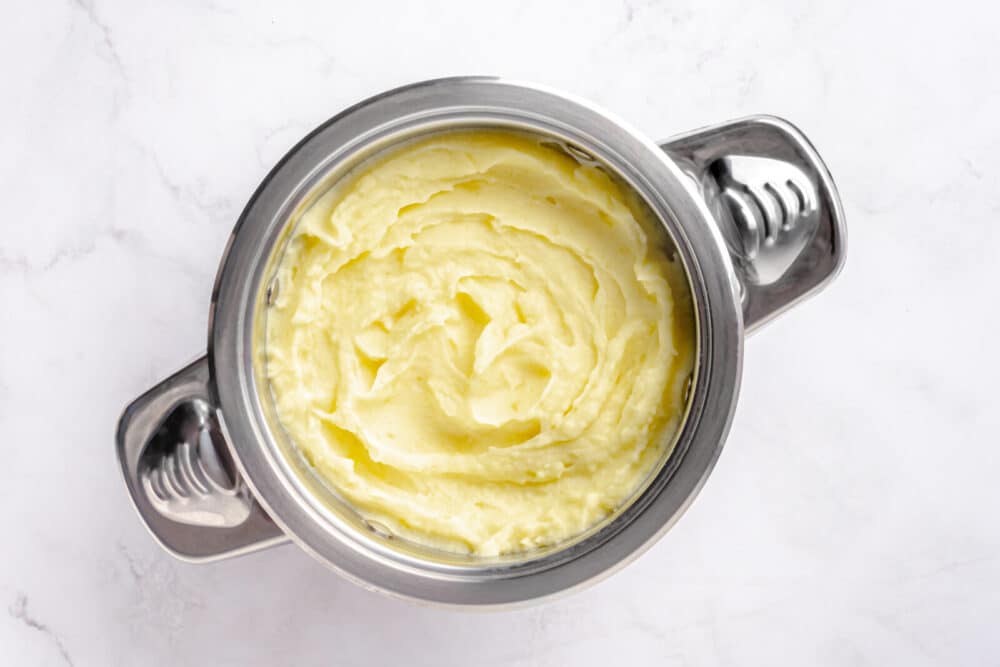 buttery mashed potatoes cooked in a pot.