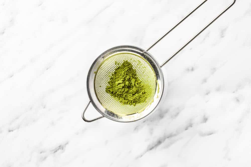 matcha powder in a sieve.