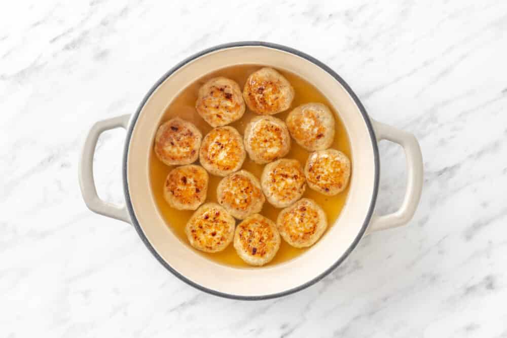 Meatballs in a pot with water.