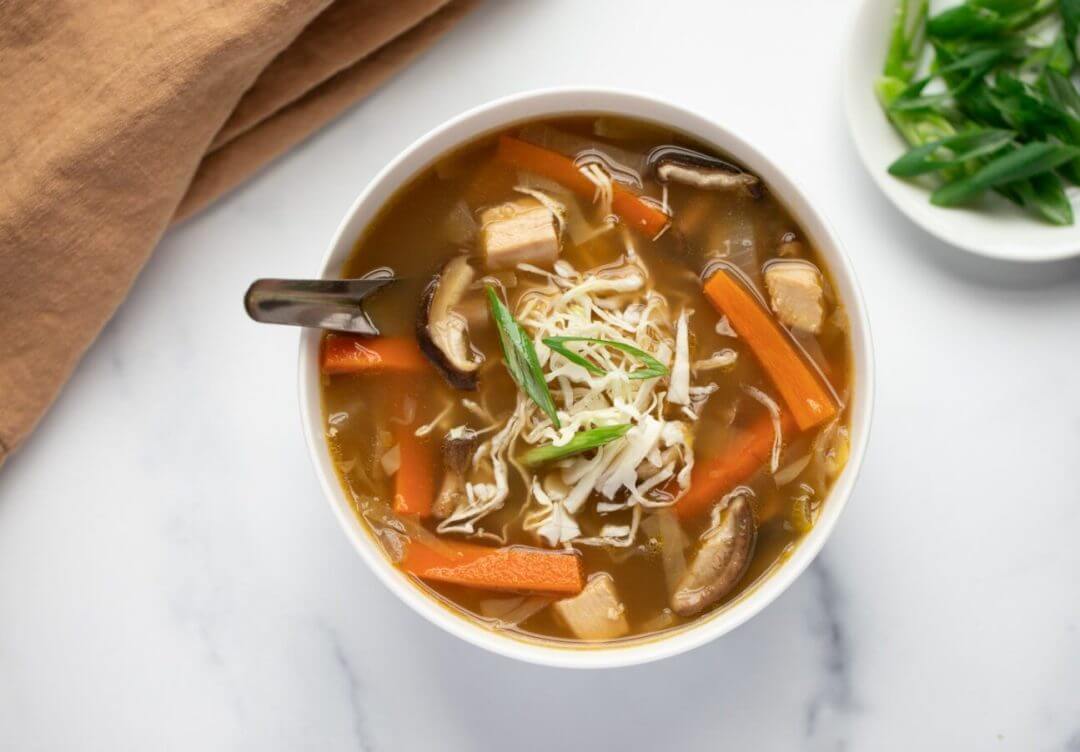 miso-mushroom-soup-in-a-white-bowl-with-a-brown-towel-on-the-side