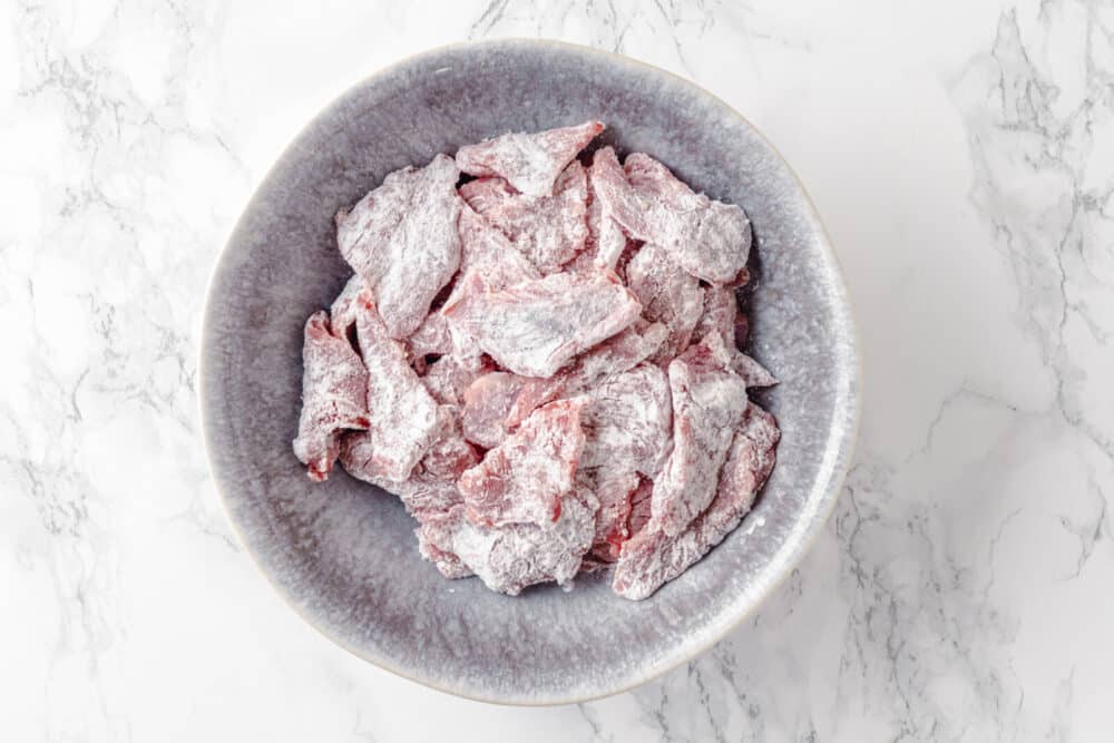 beef in cornstarch in a bowl.