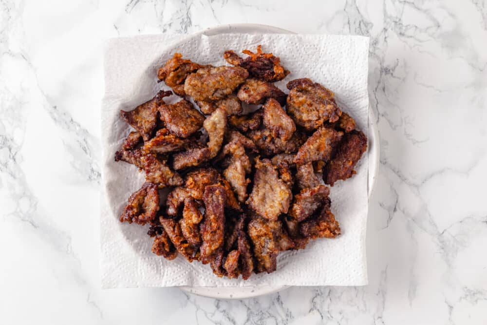 fried beef in oil on a paper towel.