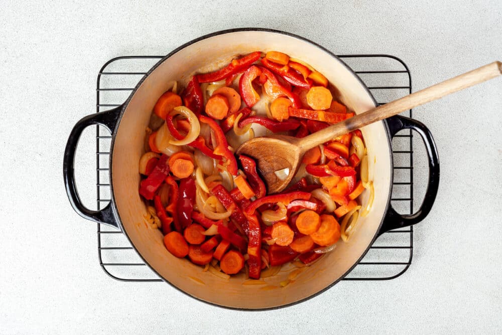 a pot of veggies with a spoon.