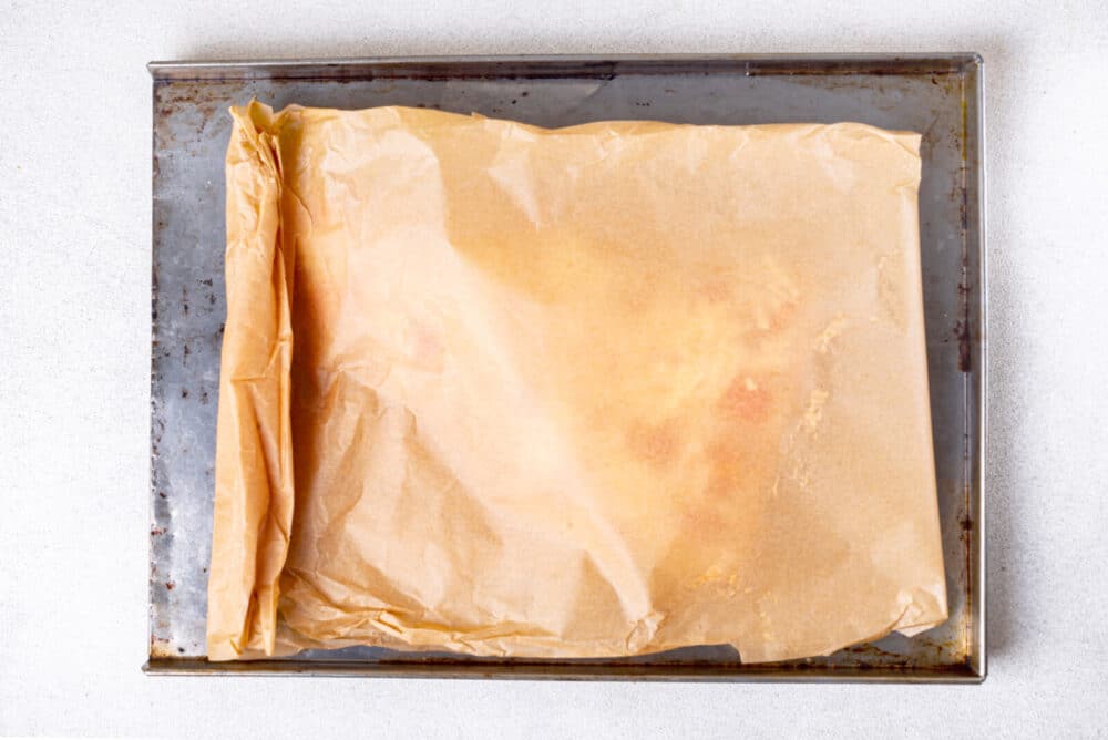 Parchment paper covering salmon ready to bake.