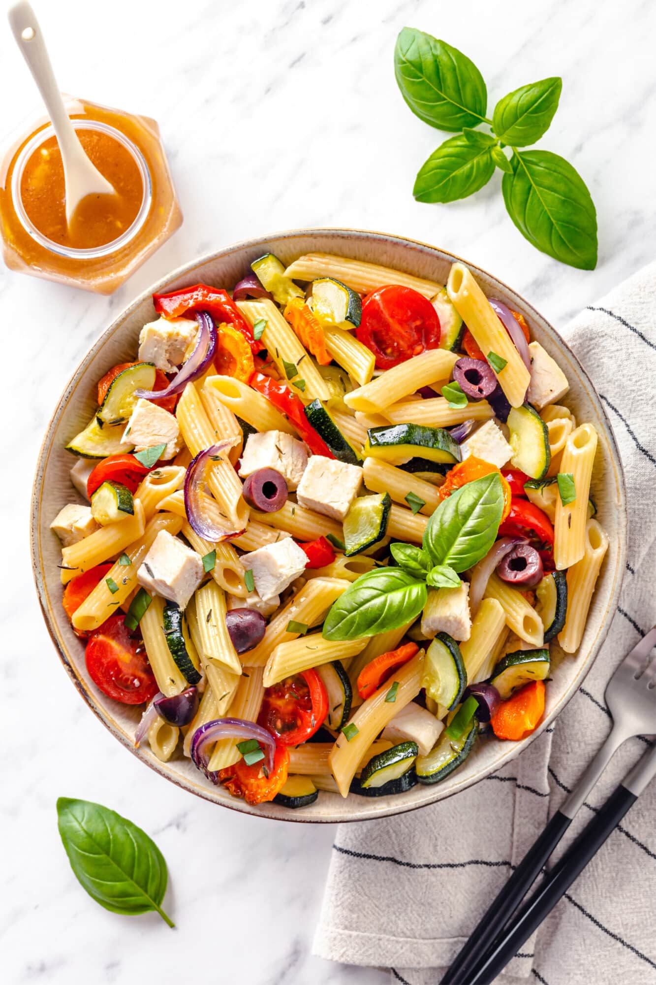 Pasta salad with chicken, olives, and roasted veggies.